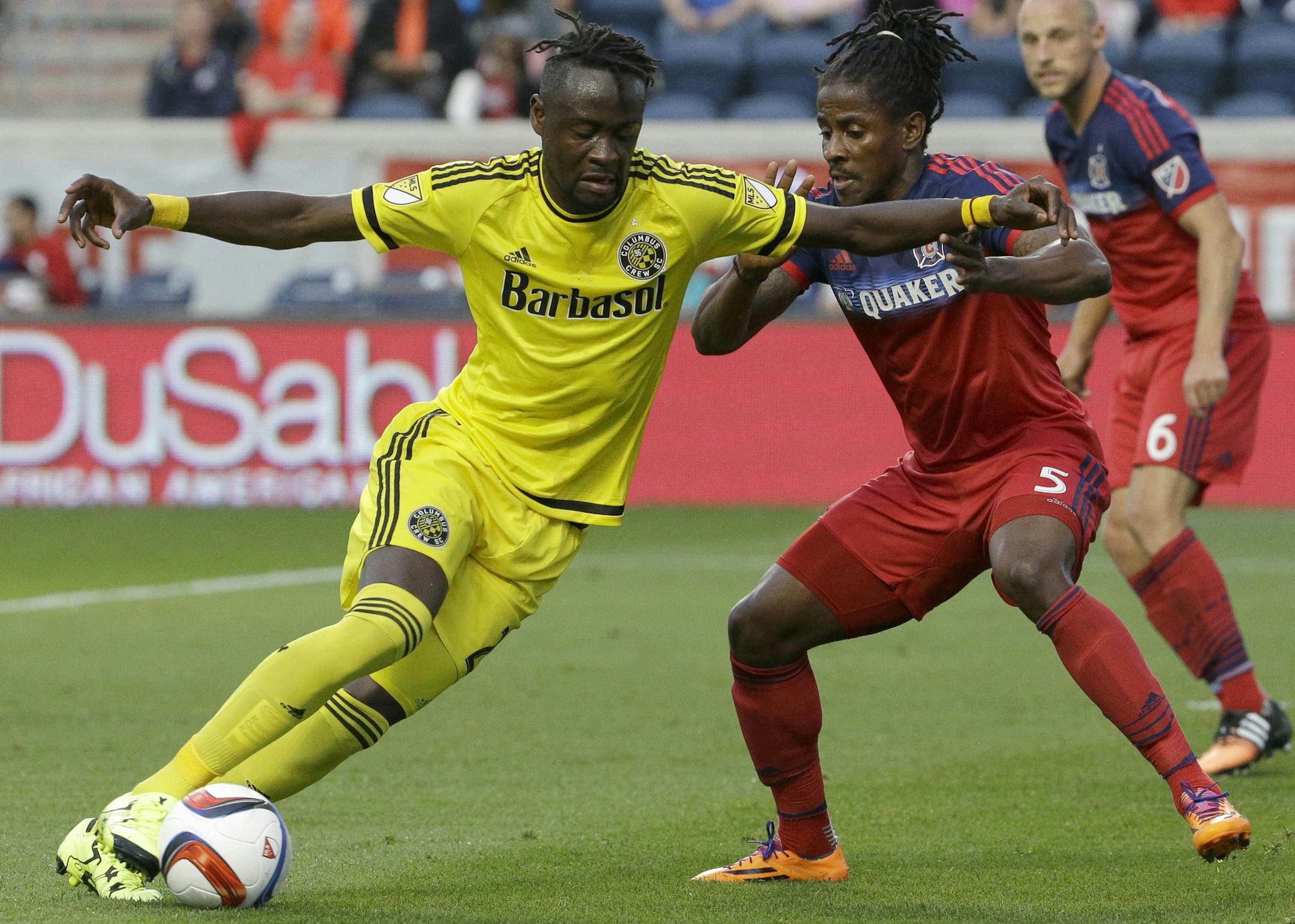Columbus Crew forward Kei Kamara, left, controls the ball against Chicago Fire defender Lovel Palmer during the first half of an MLS soccer match Wednesday, July 15, 2015, in Bridgeview, Ill. (AP Photo/Nam Y. Huh) ORG XMIT: ILNH103