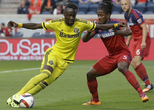 Columbus Crew forward Kei Kamara, left, controls the ball against Chicago Fire defender Lovel Palmer during the first half of an MLS soccer match Wedn