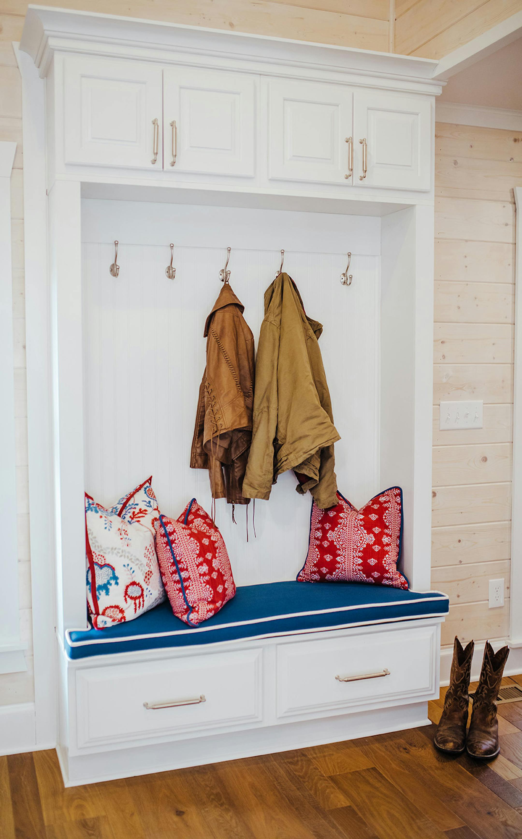 Give wasted space purpose with functional furniture. A bench with cubbies can make a compact mudroom perfect for open-concept houses.