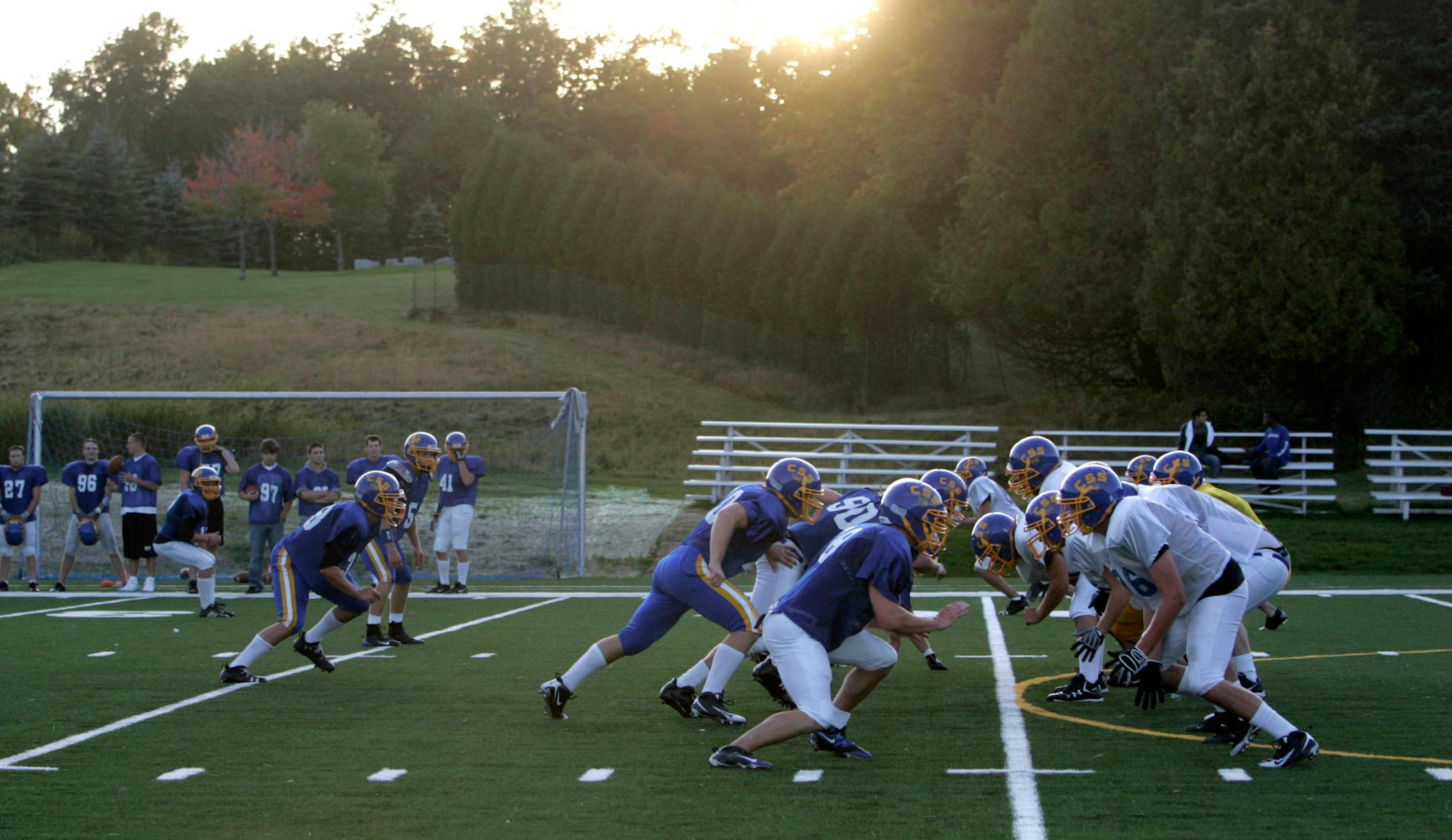 Action at the line of scrimmage at Saint Scholastica's football practice took place at the center of a soccer field nestled between the college's convent and the sisters' cemetery at the top of the hill. Eighty-four players, including 57 freshmen, signed up to be part of the team's first football program.