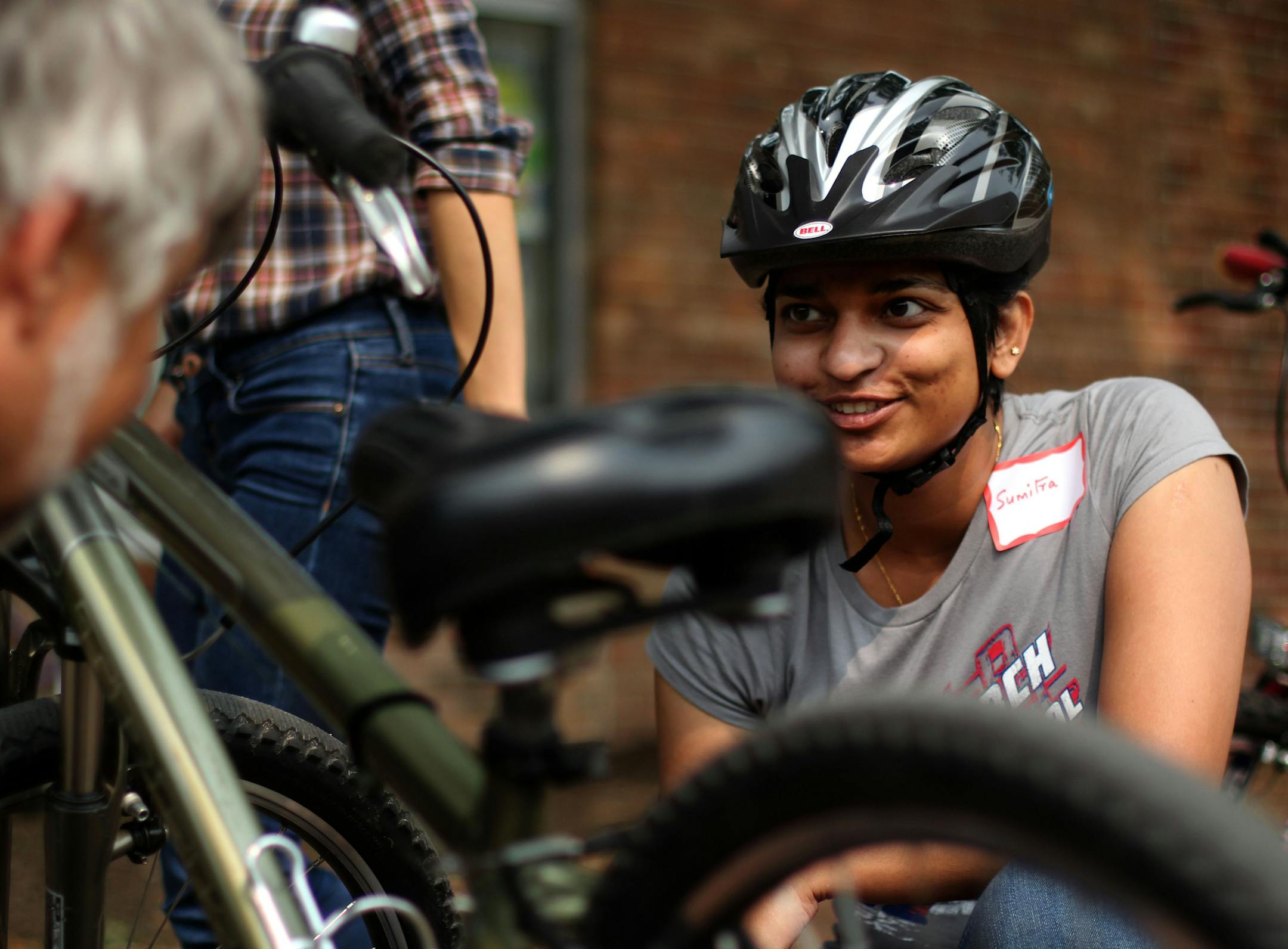Sumitra Ramachandran talks with instructor Sheldon Mains at the first lesson of a 4 week Learn-to-Ride program on Saturday morning. ] SPOKES, a non-profit in Minneapolis, offers Learn-to-Ride bike classes for adults and teens at Matthews Park in Cedar-Riverside. MONICA HERNDON monica.herndon@startribune.com Minneapolis, MN 07/19/14
