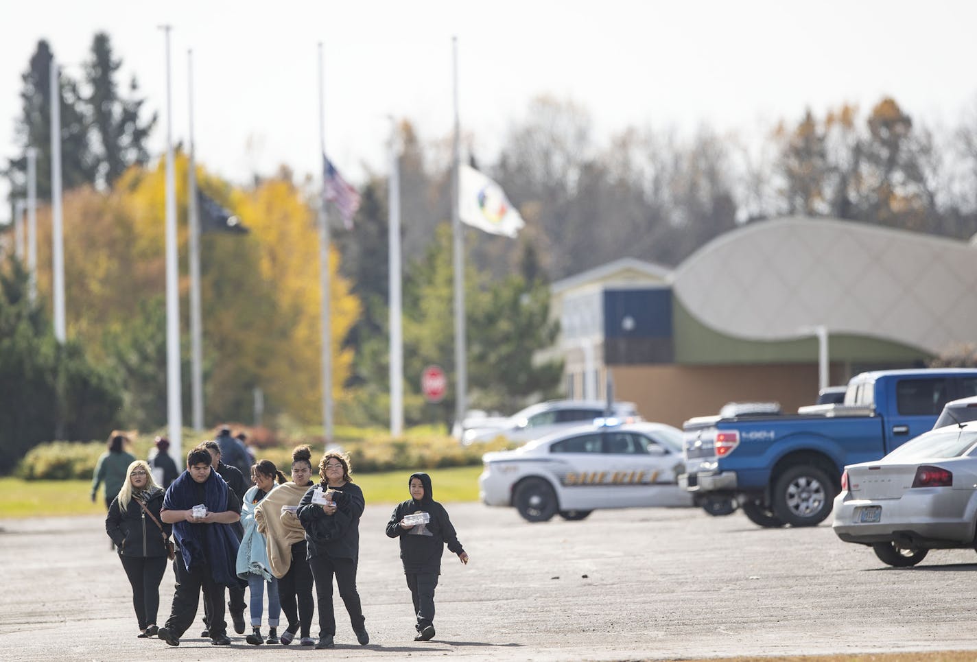 People walked away from the community center in Fond Du Lac after the lock down was lifted. The gymnasium inside is where a man was shot in the head only two hours earlier. ]
ALEX KORMANN &#x2022; alex.kormann@startribune.com A man was shot at a funeral in the Fond Du Lac Community Center gymnasium at approximately 9:46AM on Friday October 18, 2019. Schools, hospitals and tribal buildings were on lock down for over two hours.