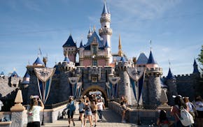 FILE - Visitors pass through Disneyland in Anaheim, Calif., April 30, 2021. Disney is seeking approval from local officials to expand its California t