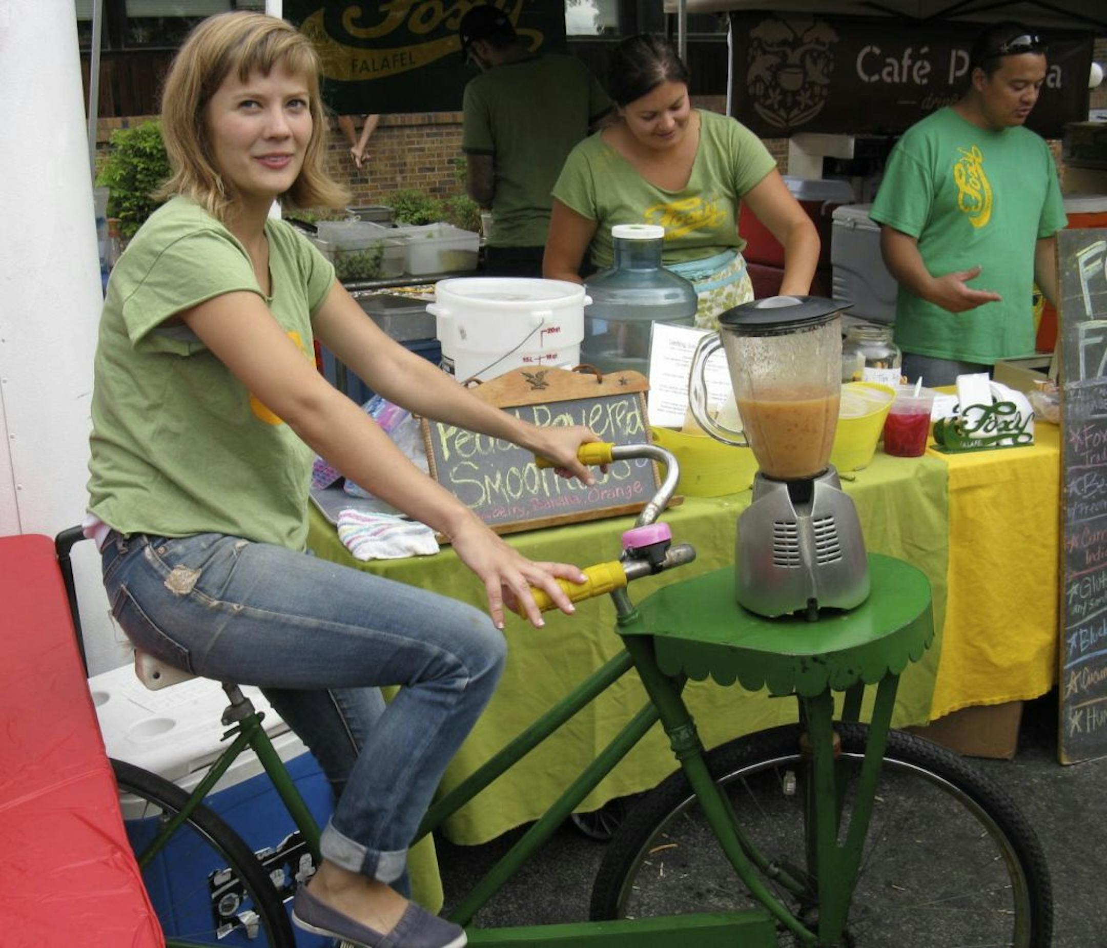 Alexis Stiteler powers the blender-bike smoothies from Foxy Falafel at the Kingfield Farmers Market.