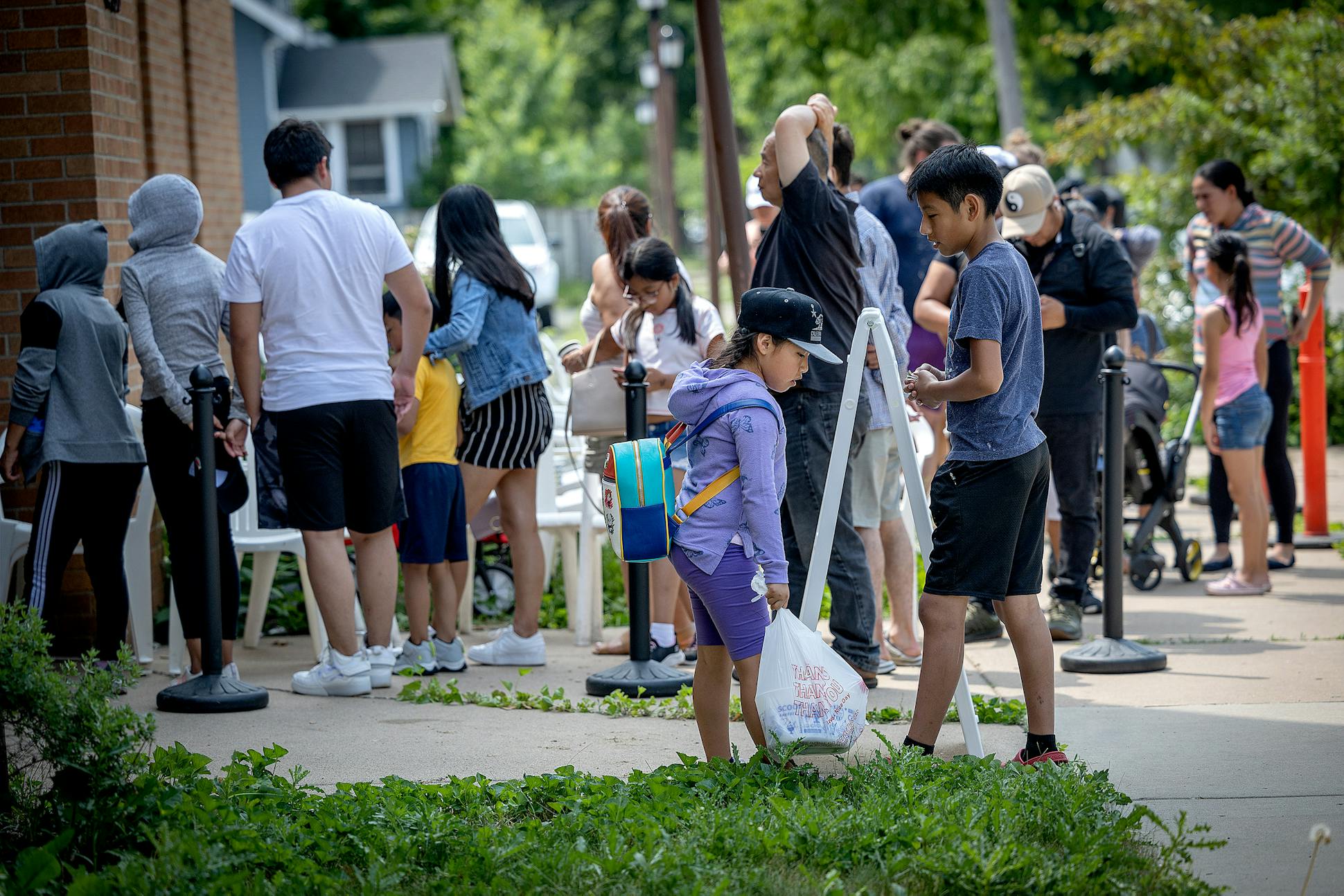 People, mostly Ecuadorians, line up to get food from a food shelf in Minneapolis.