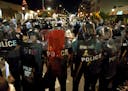 Police officers line up with shields along Delmar Boulevard in University City on Saturday, Sept. 16, 2017. A federal judge on Wednesday issued restri