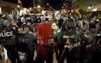 Police officers line up with shields along Delmar Boulevard in University City on Saturday, Sept. 16, 2017. A federal judge on Wednesday issued restri