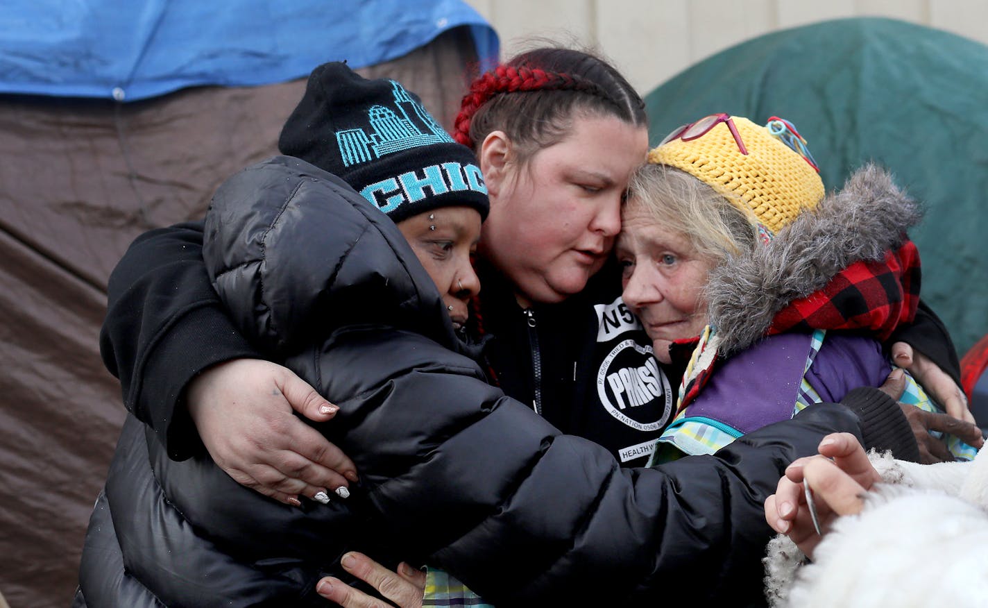 It was moving day for some at the Hiawatha homeless encampment and a day of joy and emotion for some Tuesday, Dec. 11, 2018, in Minneapolis, MN. Here, friends, volunteers and outreach workers hugged as the move had begun, including Arlene Thomas, left to right, a neighbor and friend to camp residents, Jenny Bjorgo, the camp outreach coordinator for Minnesota Indian Women's Resource Center, and Renee Avry.] DAVID JOLES &#xef; david.joles@startribune.com About a dozen residents living at the homel