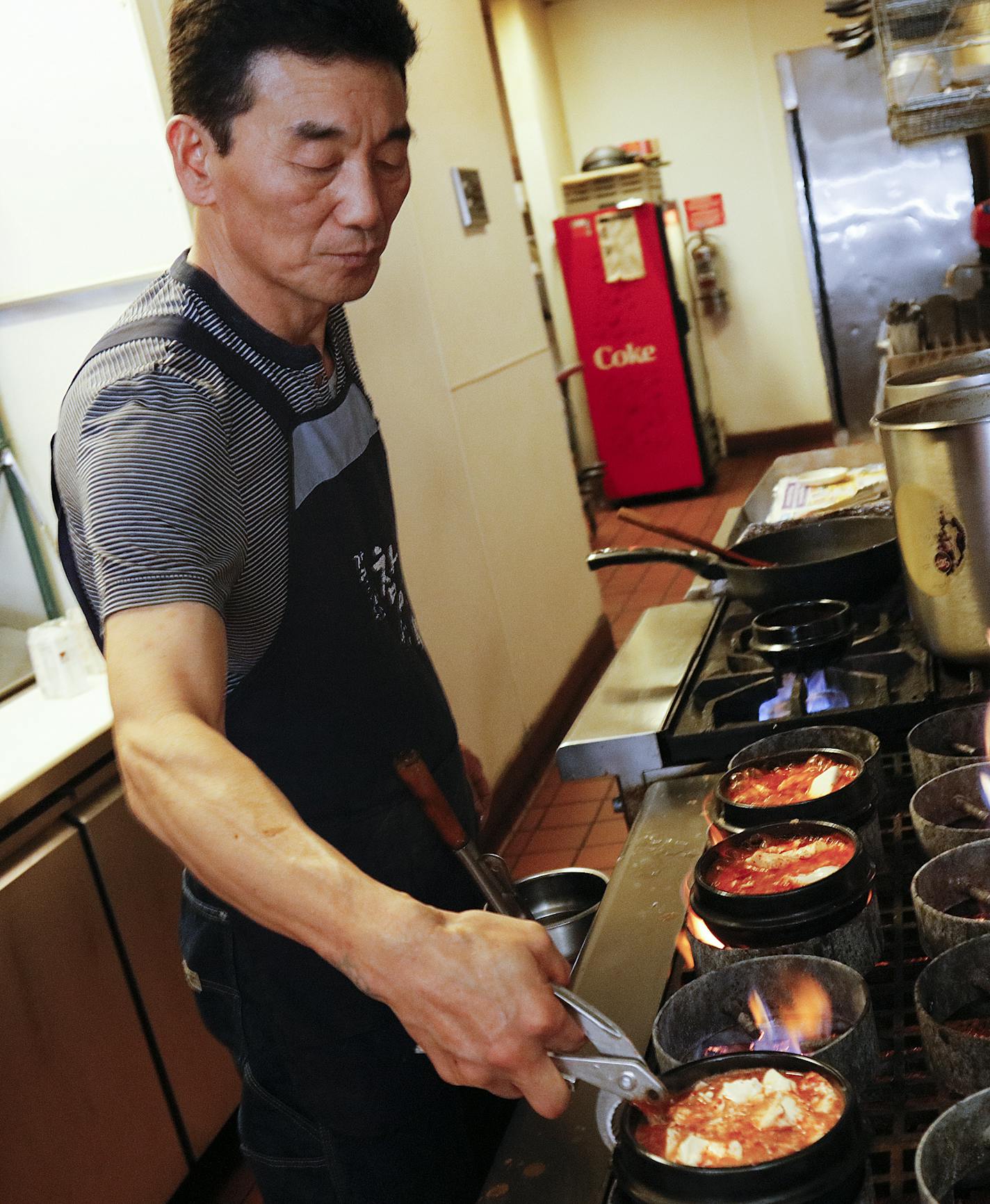 Kim Pong-Yun owner chef of the Kimchi Tofu House, cooks through the lunch hour. It is near the U of M in Minneapolis, specializes in spicy Korean soup called sundubu. It sells 12 varieties and customers can choose the level of spiciness, done by varying the amount of Korean chili flakes called gochugaru. ] Star Tribune/Tom Wallace &#x2022; tom.wallace@startribune.com