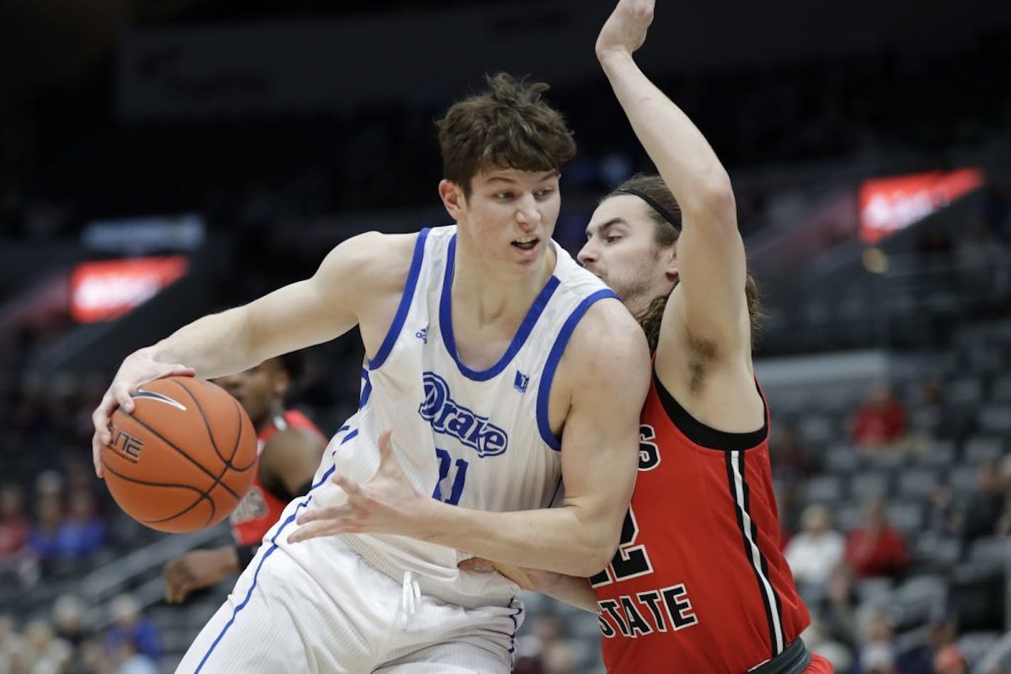 Drake's Liam Robbins, left, heads to the basket as Illinois State's Matt Chastain defends during the first half of an NCAA college basketball game in the first round of the Missouri Valley Conference men's tournament Thursday, March 5, 2020, in St. Louis.