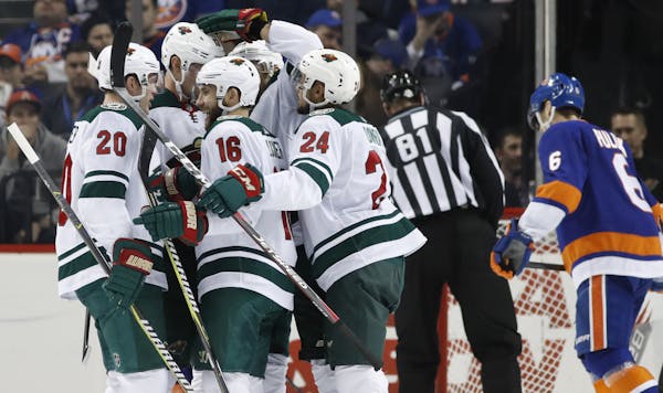 Kathy Willens Associated Press
Wild players celebrate with Jason Zucker (16) after he scored a second-period goal Monday.