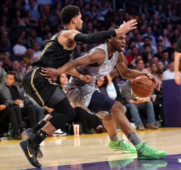 Timberwolves guard Andrew Wiggins, right, drives as Lakers forward Josh Hart defends Friday night in Los Angeles.