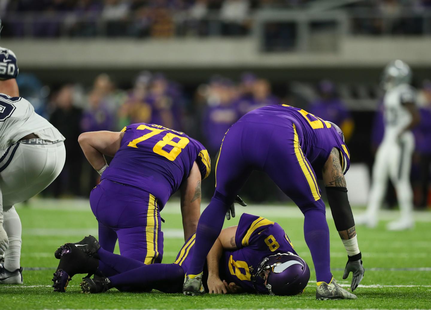 Vikings quarterback Sam Bradford (8) lay still on the turf after a hard hit in the second quarter.