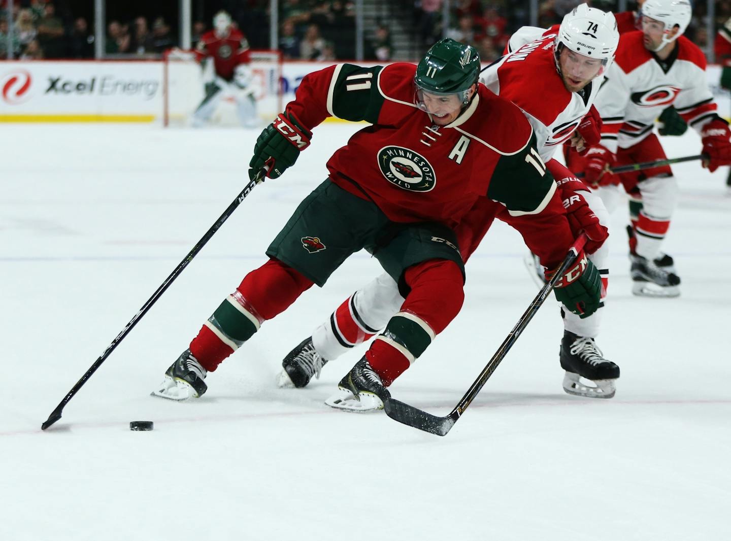 Wild left wing Zach Parise drive down the ice during a first period play with Hurricanes defender Jacob Slavin in persuit.