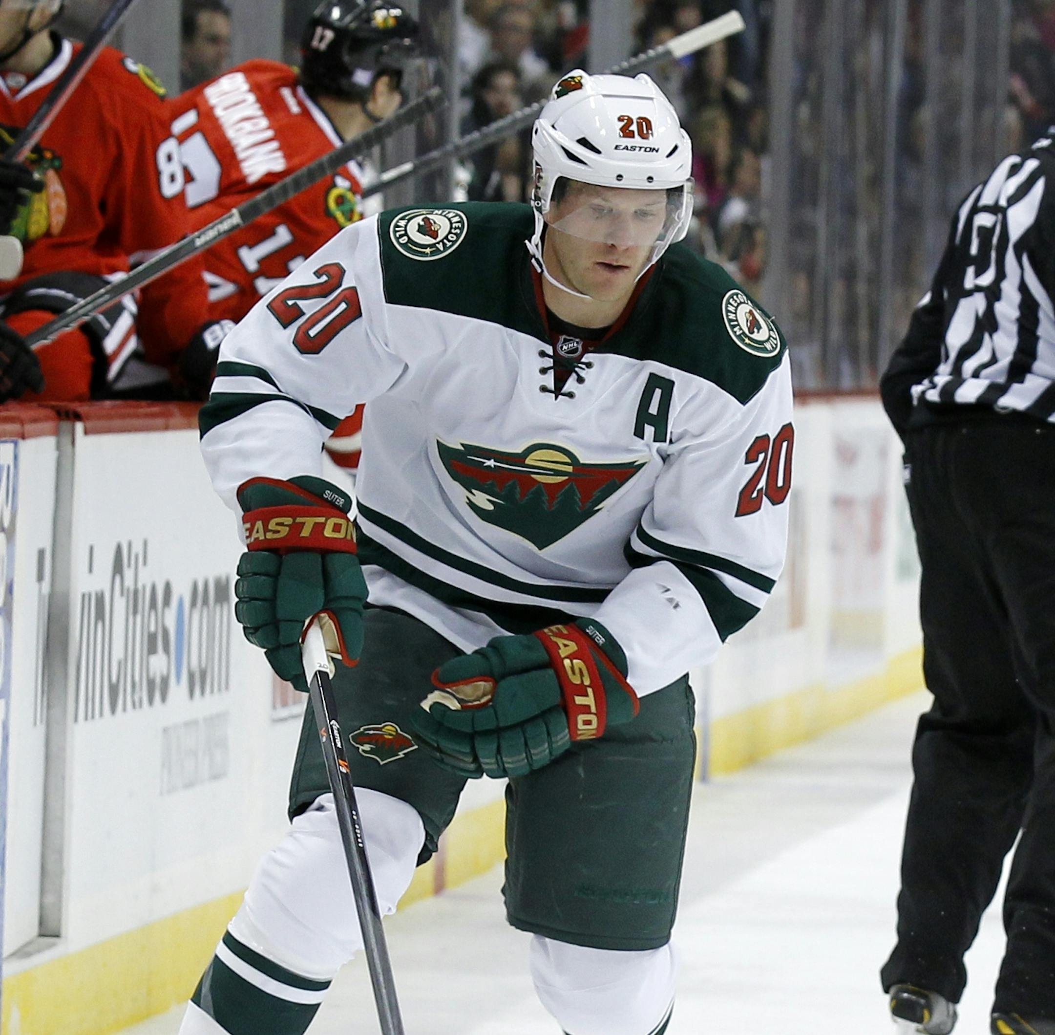 Minnesota Wild defenseman Ryan Suter (20) controls the puck during the second period of an NHL hockey game against the Chicago Blackhawks in St. Paul , Minn., Monday, Oct. 28, 2013. (AP Photo/Ann Heisenfelt)