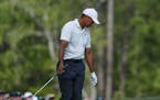 Tiger Woods reacts after hitting in the water on the 12th hole during the second round at the Masters golf tournament Friday, April 6, 2018, in August