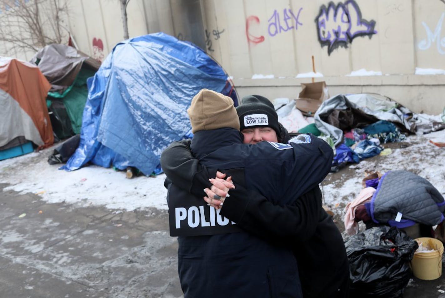 It was moving day for some at the Hiawatha homeless encampment and a day of joy and emotion for some Tuesday, Dec. 11, 2018, in Minneapolis, MN. Here, Jenny Bjorgo, the camp outreach coordinator for Minnesota Indian Women's Resource Center, hugs Minneapolis Police Sgt. Grant Snyder as the move began. Bjorgo told Grant that they and other agencies had cooperated to care for and move an entire community of homeless, something Bjorgo said "had never been done before" in the United States.