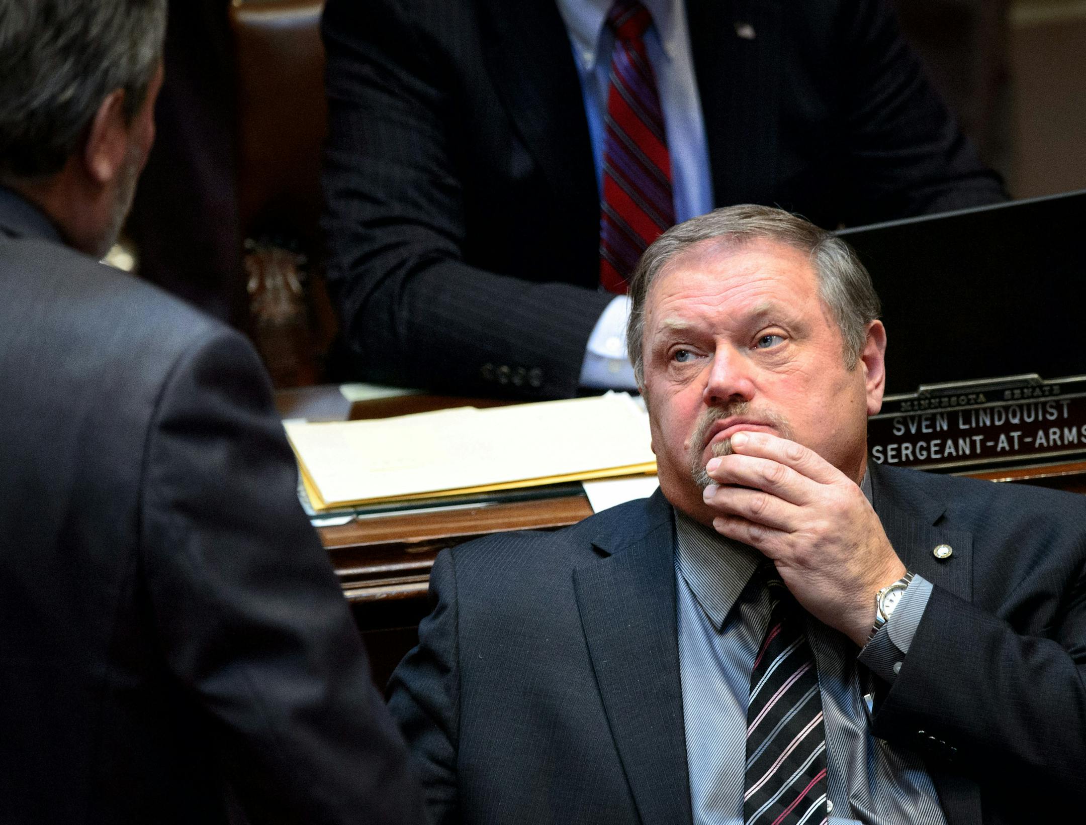 Majority Leader Tom Bakk rubbed his chin as he spoke with Sen Rod Skoe while the Senate debated the bill with Bakk's amendment that would delay raises for Governor Dayton's commissioners. ] GLEN STUBBE * gstubbe@startribune.com Thursday, February 12, 2015
