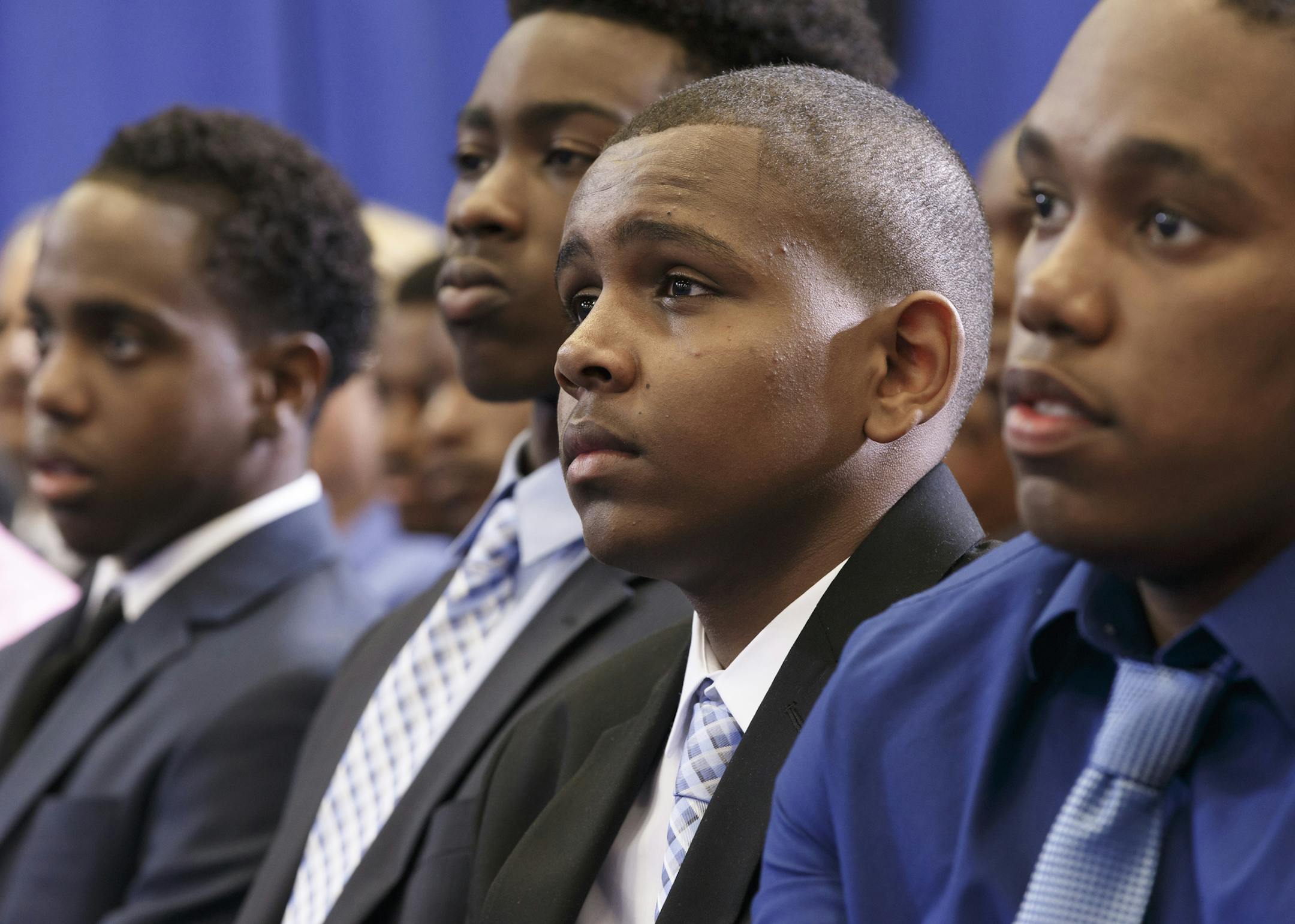 Young African-American men listen intently as President Barack Obama speaks at a "town hall meeting" about the My Brother&#xed;s Keeper Initiative, at the Walker Jones Education Campus in Washington, Monday, July 21, 2014. President Obama announced that leaders of 60 of the largest school systems have pledged to expand minority boys' access to better preschools and advanced classes and to try to prevent grade retention, suspensions and expulsions. (AP Photo/J. Scott Applewhite)