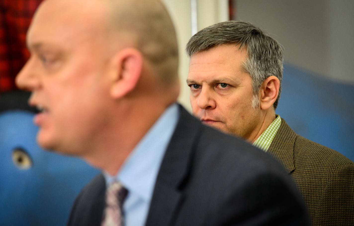 Brian Beutner, MNsure Chairman watched as Interim CEO Scott Leitz spoke at a press conference in the the morning after former CEO April Todd-Malmlov resigned. Wednesday, December 18, 2013 ] GLEN STUBBE * gstubbe@startribune.com EDS, Beutner has a tan jacket, Leitz has a blue jacket and close shaved hair.