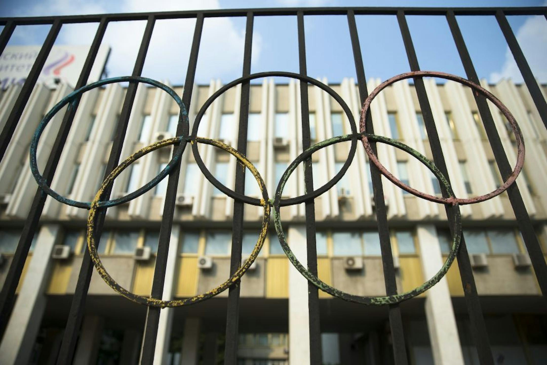 The Olympics rings are seen on a fence in front of the Russian Olympic Committee building in Moscow, Russia, Sunday, July 24, 2016. The IOC has decided against a complete ban on Russian athletes from the Olympics in Rio de Janeiro. The International Olympic Committee says it is leaving it up to global federations to decide which Russian athletes to accept in their sports.