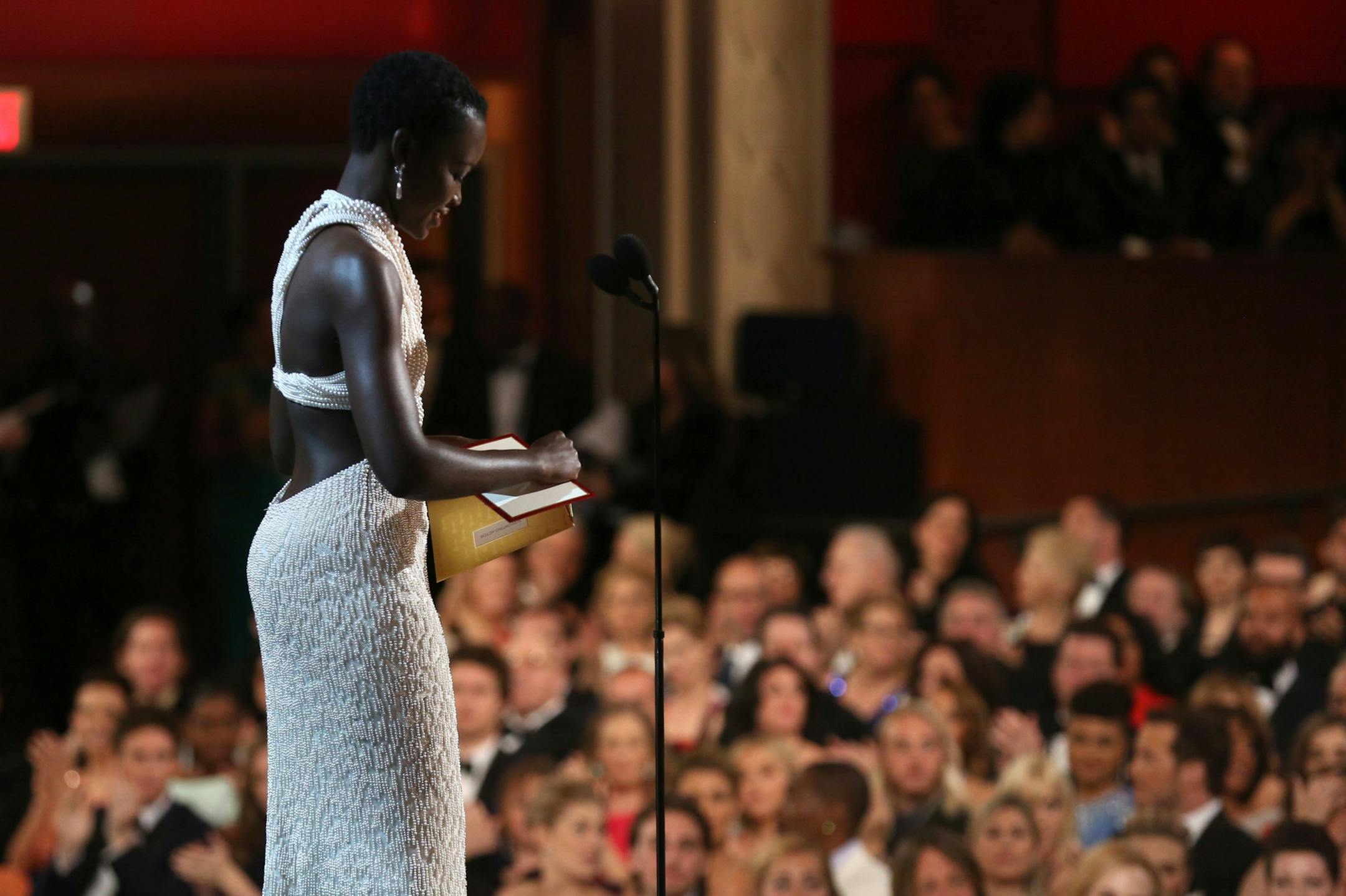 Lupita Nyong'o is seen from backstage as she presents the award for best actor in a supporting role at the Oscars on Sunday, Feb. 22, 2015, at the Dolby Theatre in Los Angeles.