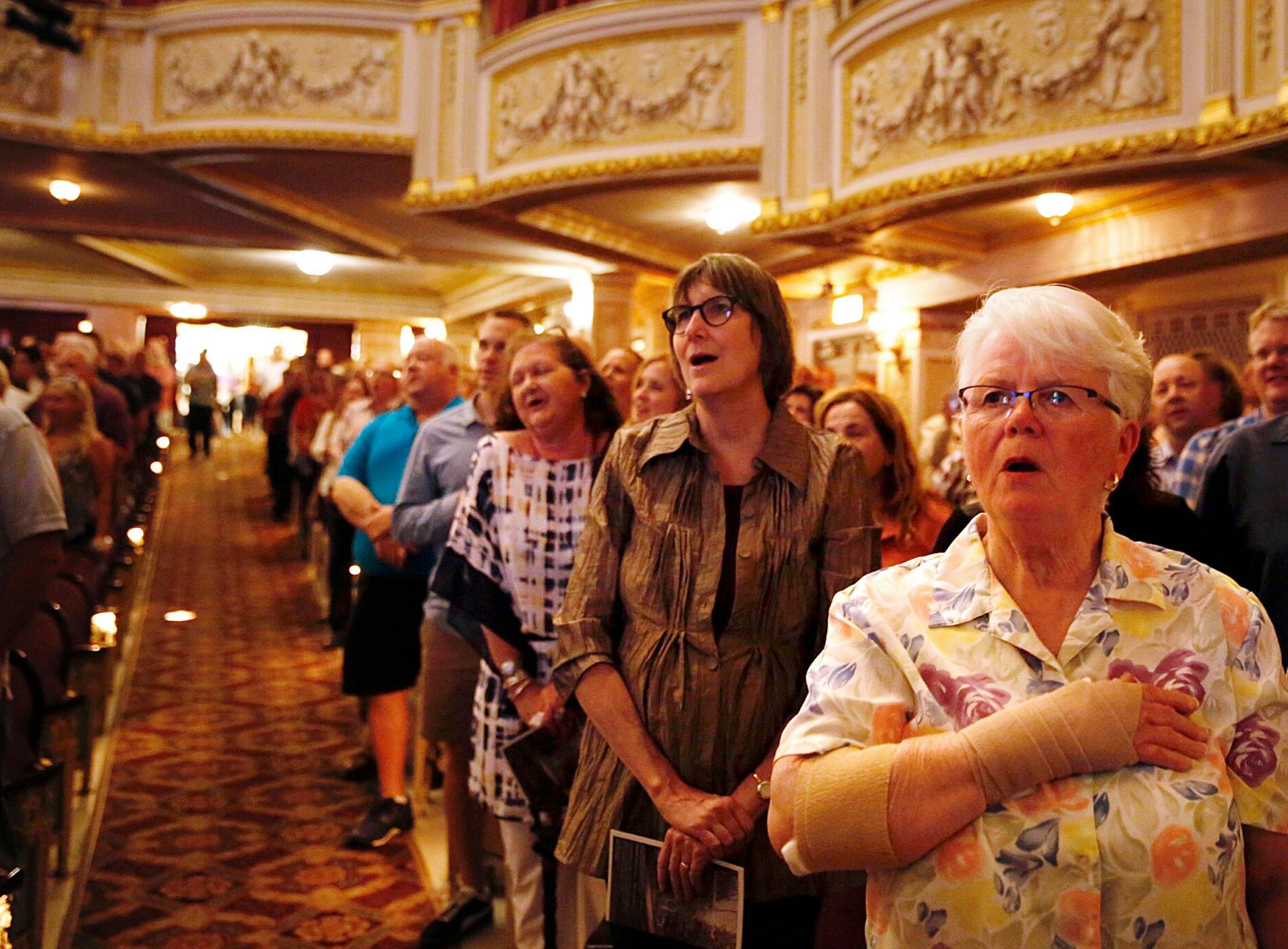Kathy Beatty of Inver Grove Heights sings the "Star Spangled Banner" with Garrison Keillor during the warm up. ] (LEILA NAVIDI /STAR TRIBUNE) leila.navidi@startribune.com Garrison Keillor's last time as host for "Prairie Home Companion" from Minneapolis is expected to draw his most die-hard fans and favorite local musicians. Photographed Saturday, May 21, 2016 at the State Theatre in Minneapolis.