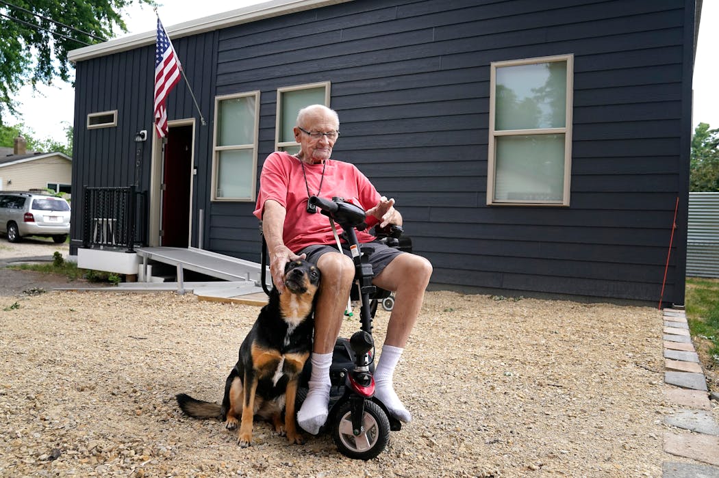 Ed Meyers outside his ADU with his service dog, Casey.
