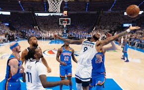 The Timberwolves' Nickeil Alexander-Walker reaches for a rebound of his own shot in the first half of Wednesday night's loss at Oklahoma City.
