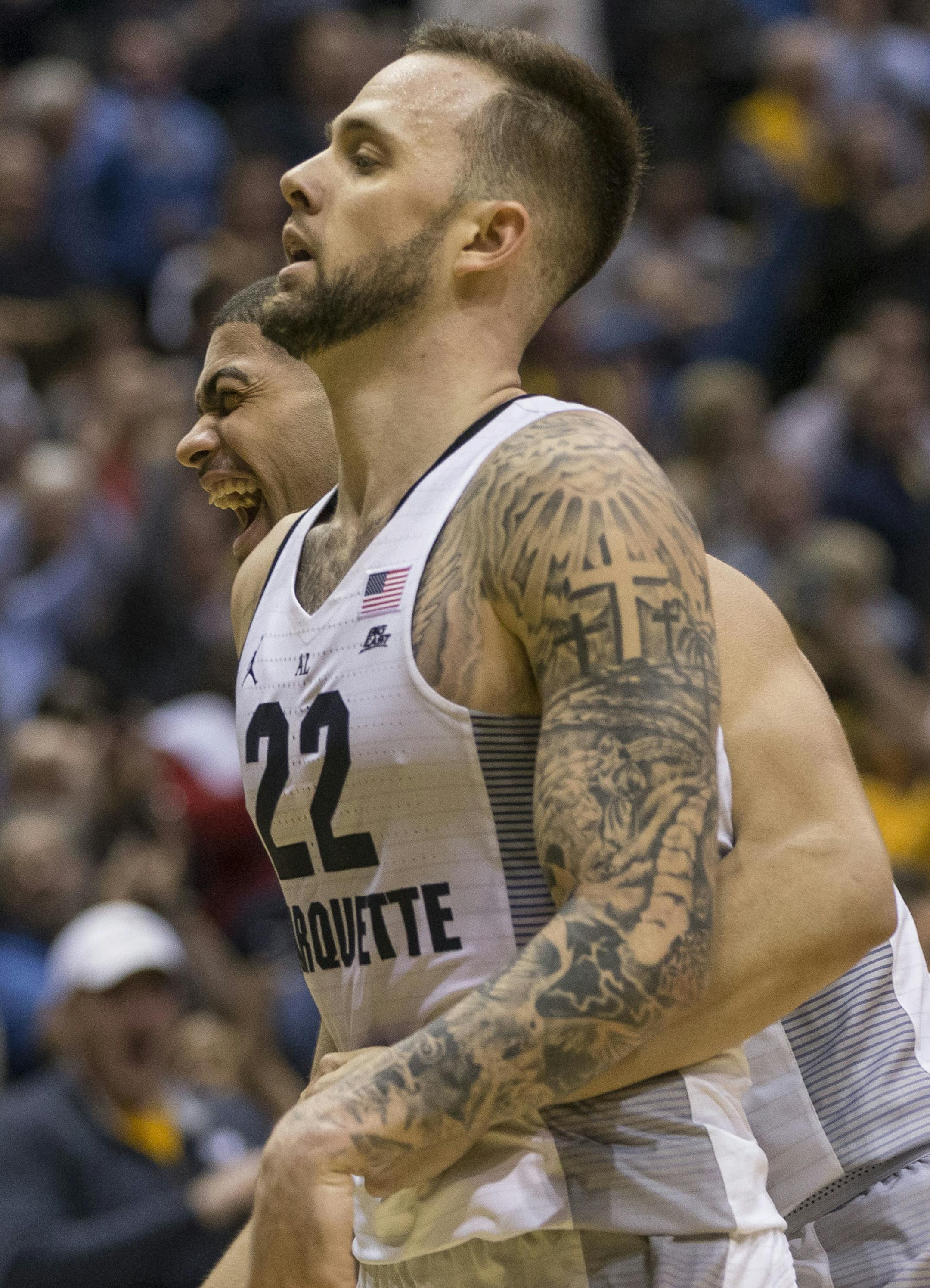 Marquette's Katin Reinhardt and Jajuan Johnson react to Reinhardt's three point shot to tie the game against number one ranked Villanova during the second half of an NCAA college basketball game Tuesday, Jan. 24, 2017, in Milwaukee. Marquette defeated Villanova 74-72. (AP Photo/Tom Lynn)