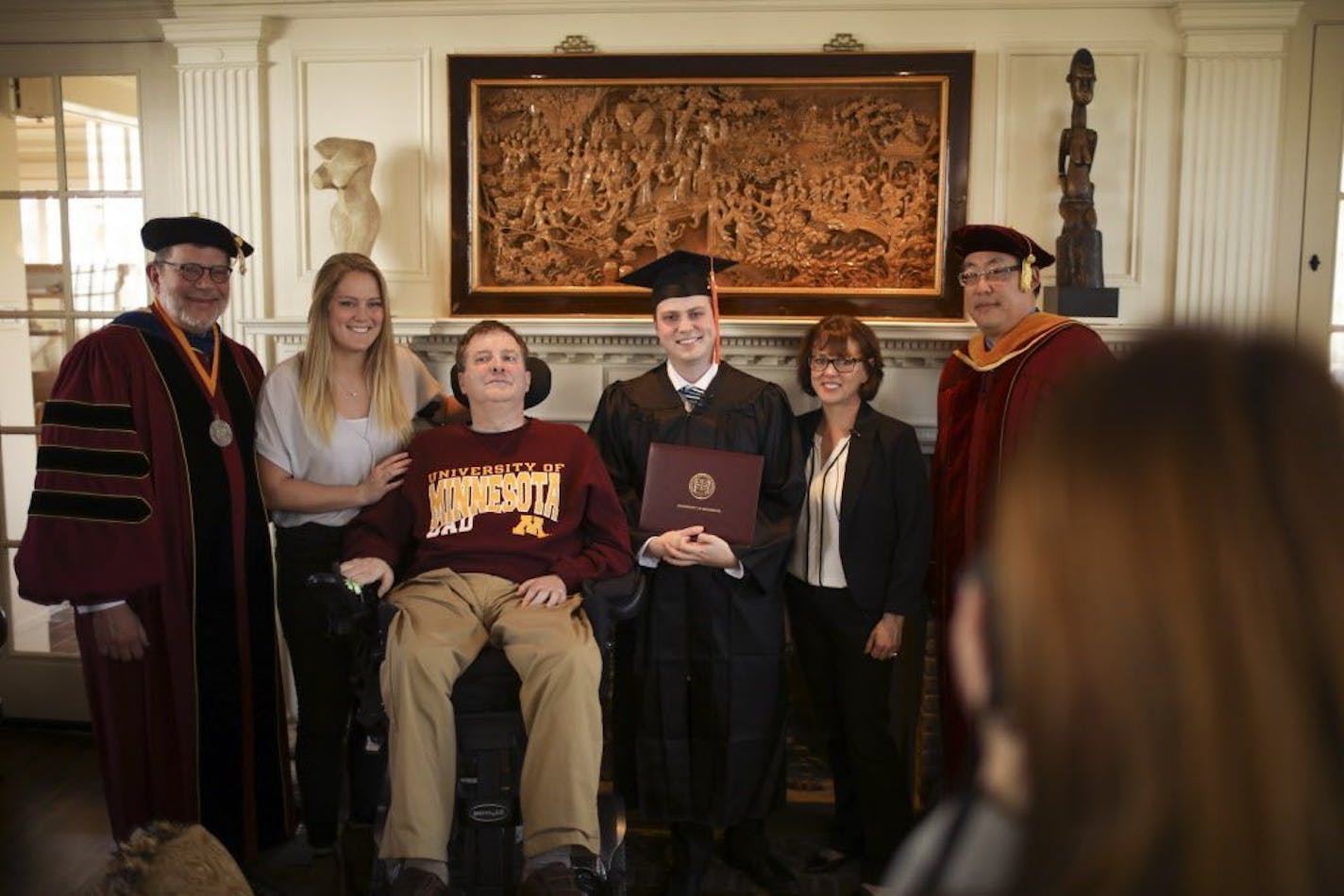 The Brown family posed for a photo by a family friend after Collin received his diploma Monday afternoon. From left are University President Eric Kaler, Colln's sister, Keegan, father Ken, Collin, mother Patti, and Regent Michael Hsu.