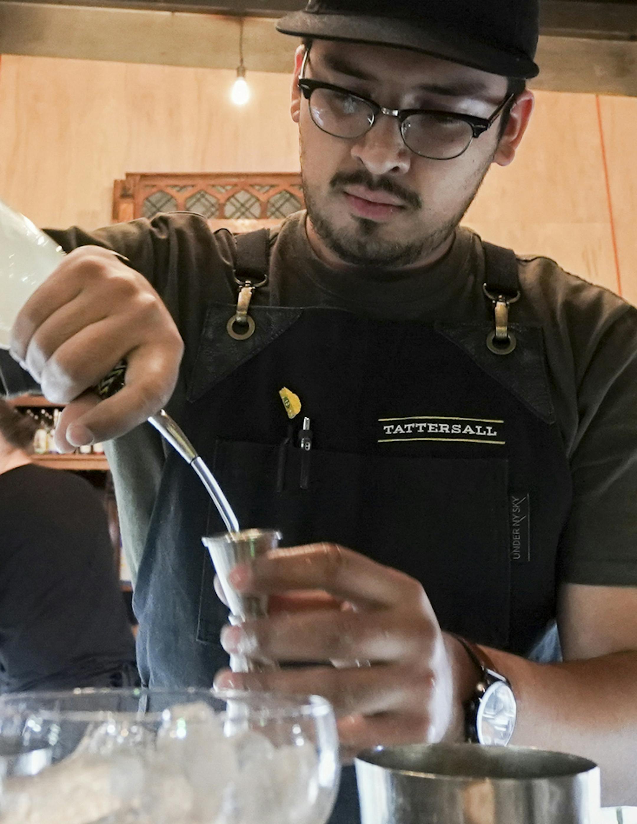 Bartender Brandon Gonzalez mixed beverages for guests at the bar. ] MARK VANCLEAVE ¥ Guests filed in to Tattersal Distilling for after-work cocktails and craft spirits Thursday, Dec. 5,2019 in Minneapolis.