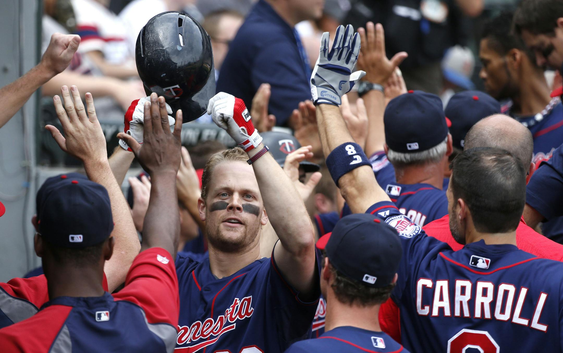 Minnesota Twins' Justin Morneau (33) celebrates in the dugout his grand slam scoring Joe Mauer, Pedro Florimon and Clete Thomas off Chicago White Sox relief pitcher Nate Jones during the seventh inning of a baseball game on Friday, Aug. 9, 2013, in Chicago. (AP Photo/Charles Rex Arbogast) ORG XMIT: MIN2013080923162871