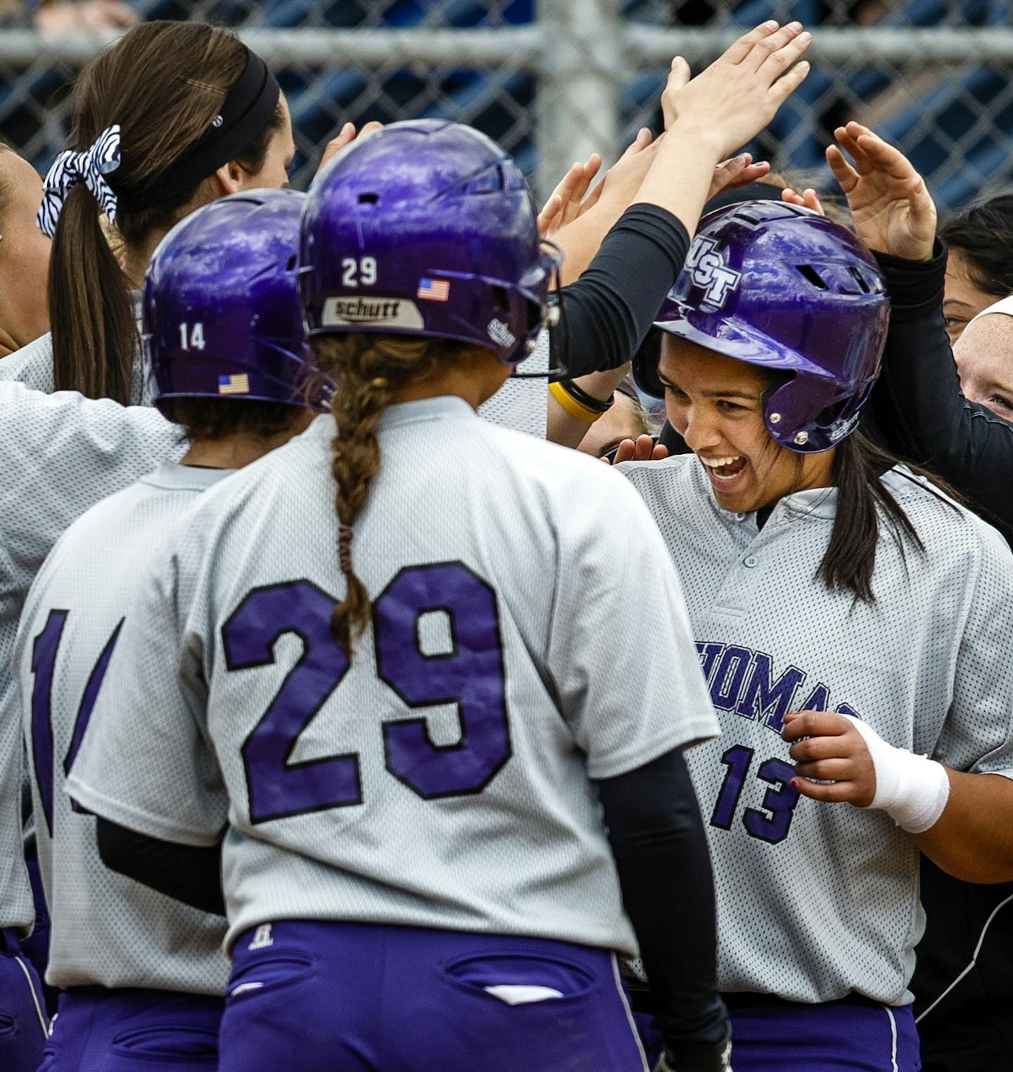 Brenna Walek gets mobbed at the plate after bashing a three-run home run during the MIAC Championship softball game against Bethel College May 3, 2014 at Macalester College's softball field. The Tommies won 7-2. MANDATORY CREDIT: Mike Ekern / University of St. Thomas