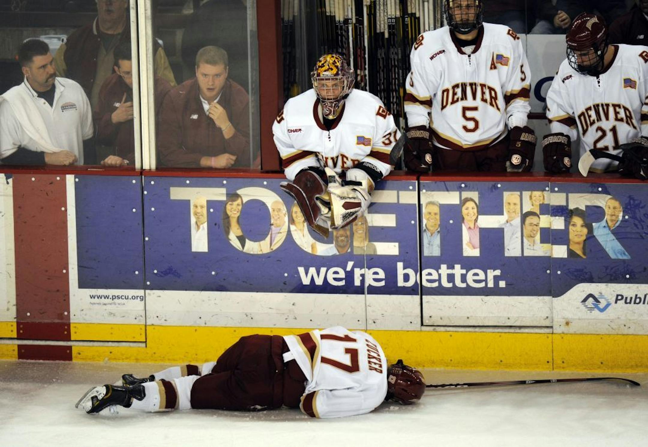 University of Denver Jason Zucker (17) is down on the ice after the fouled by Minnesota Kyle Rau (7) in the 2nd period of the game at Magness Arena in Denver , CO. on Friday, Feb. 10, 2012.