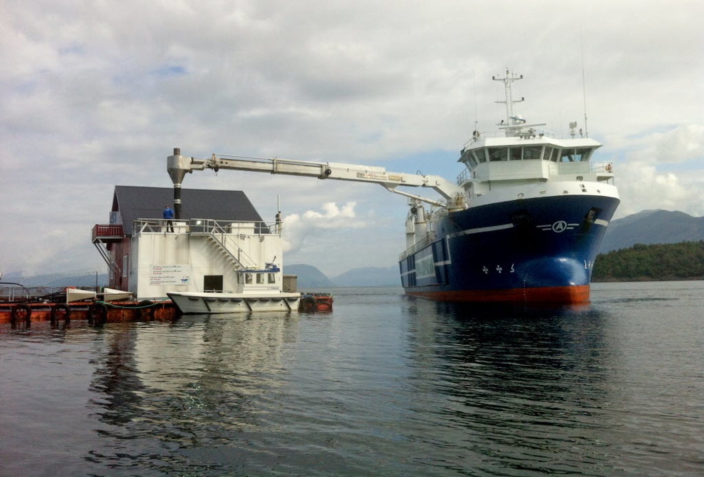 A ship unloads feed at a Cargill salmon farm.