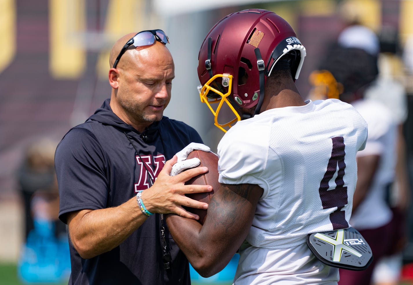 Gophers coach P.J. Fleck speaks with wide receiver Corey Crooms Jr. during Tuesday's practice at Athlete Village.