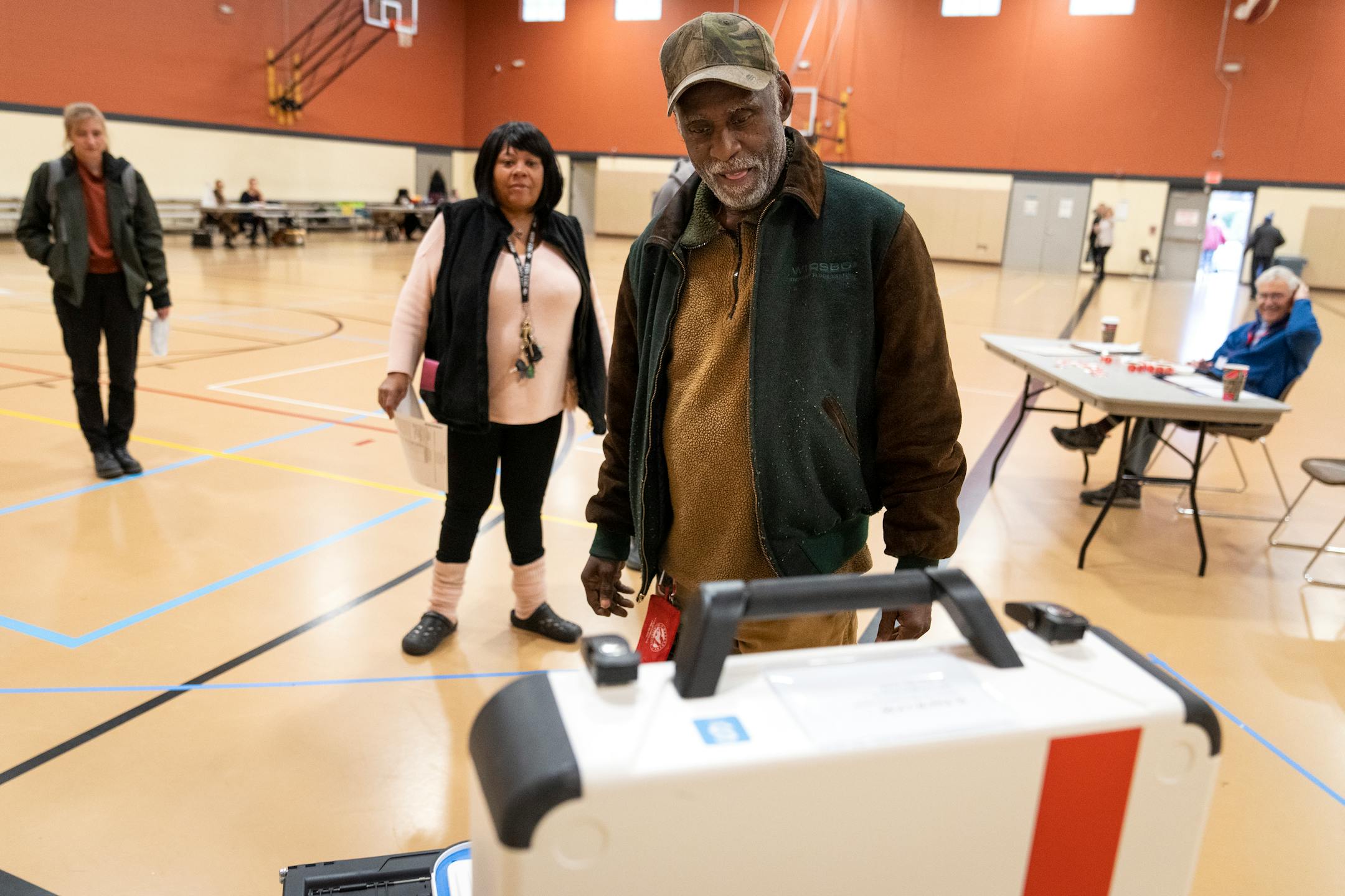 Leonard Salley inserts his ballot into the machine after voting at Jimmy Lee Recreation Center on Election Day in Ward 1 of St. Paul.