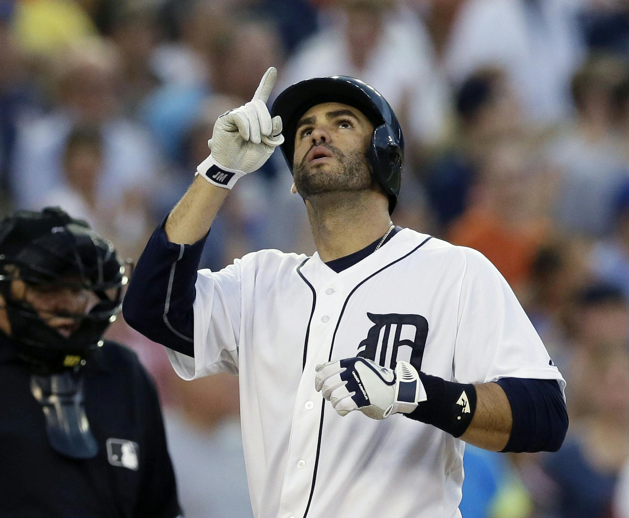 Detroit Tigers' J.D. Martinez points skyward after his solo home run during the fifth inning of a baseball game against the Baltimore Orioles, Friday, July 17, 2015, in Detroit. (AP Photo/Carlos Osorio)