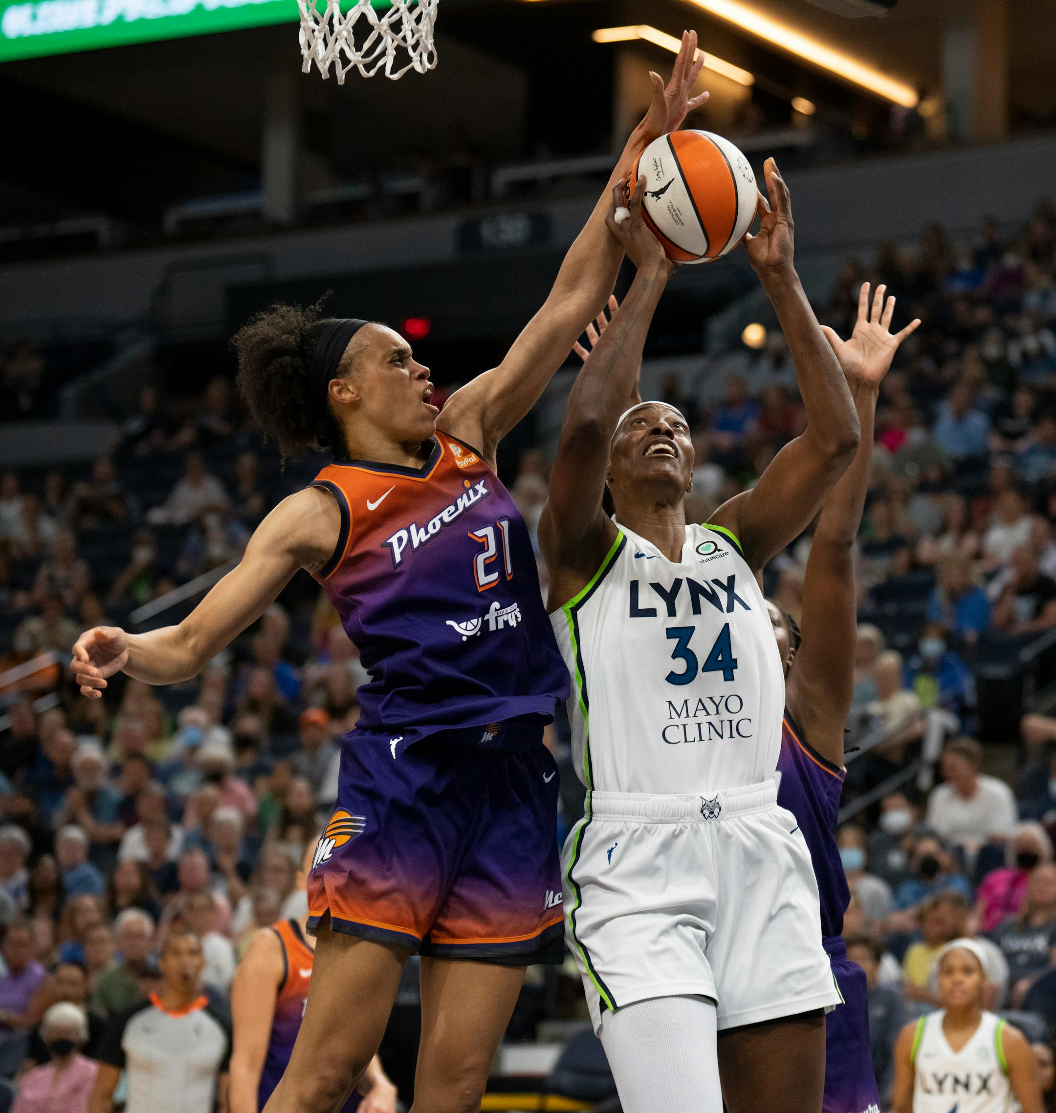 In her first game back after an injury, Minnesota Lynx center Sylvia Fowles (34) split the defense of Phoenix Mercury forward Brianna Turner (21) and Mercury center Tina Charles (31) while on a second quarter drive.