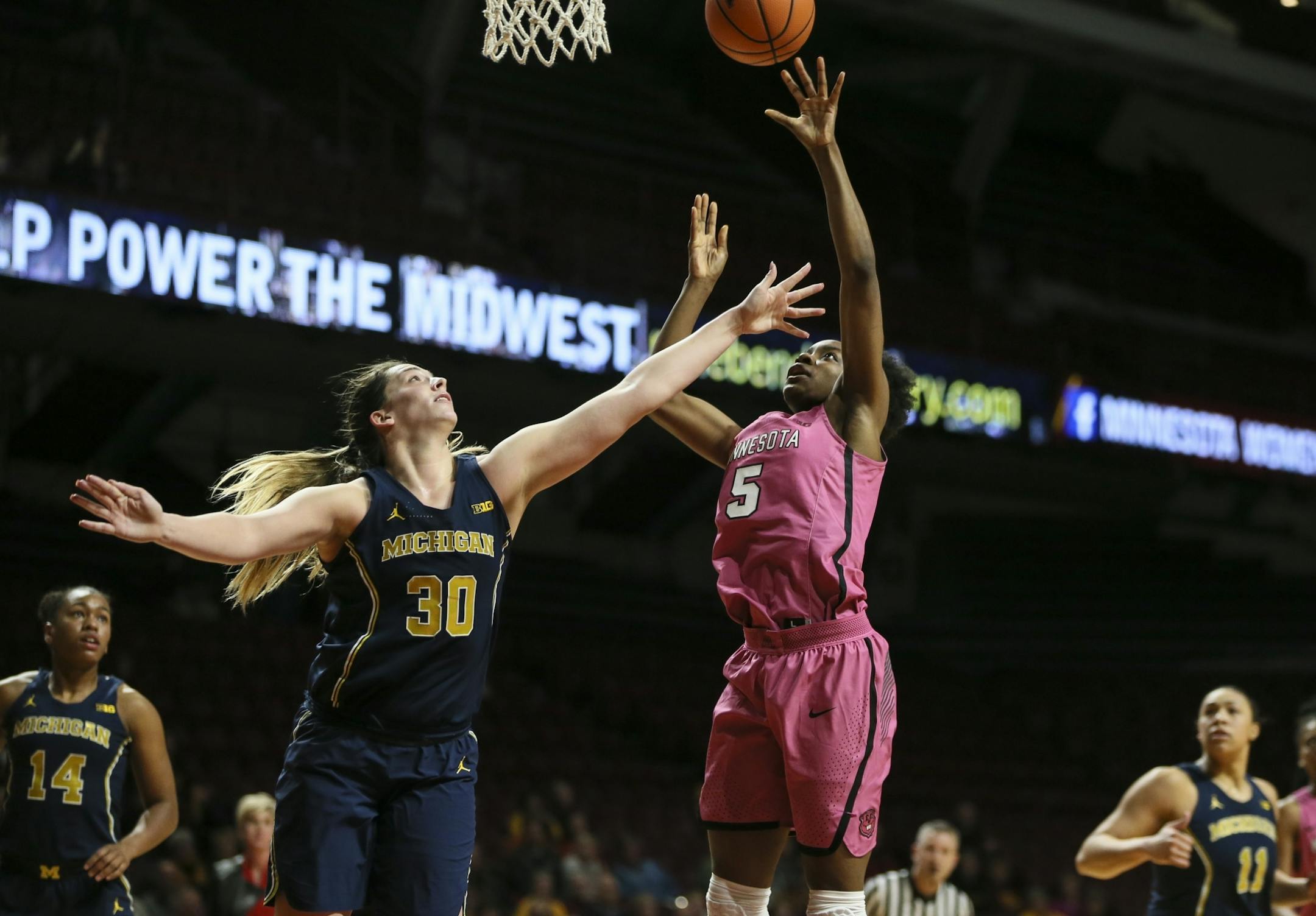 Minnesota Golden Gophers forward Taiye Bello (5) jumped for a shot against Michigan Wolverines Hallie Thome (30) in the second half.