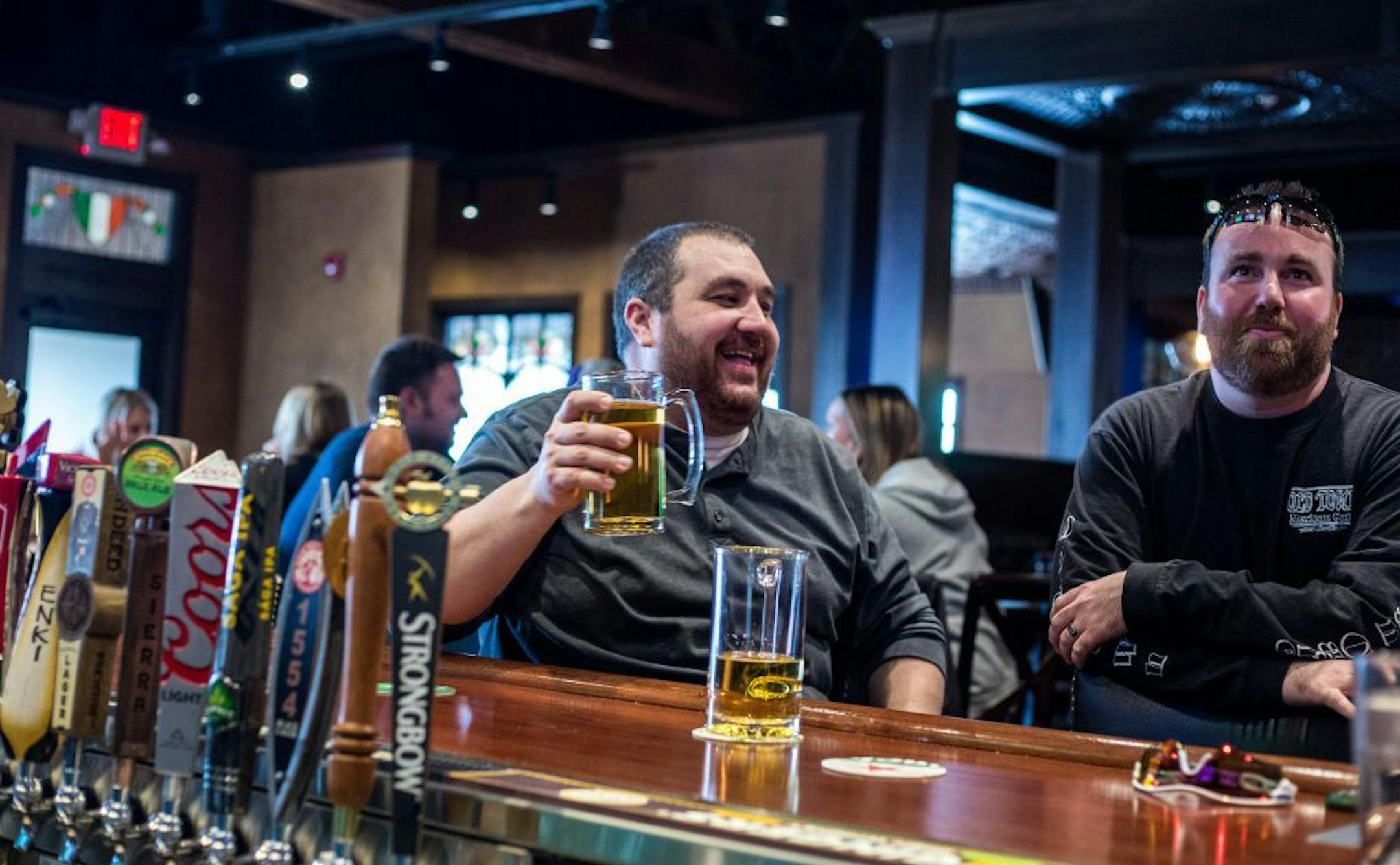 Chris Hunter, left, and Chris Mathews talk at O'Brien's Public House which recently opened in Shakopee this February,Friday afternoon.