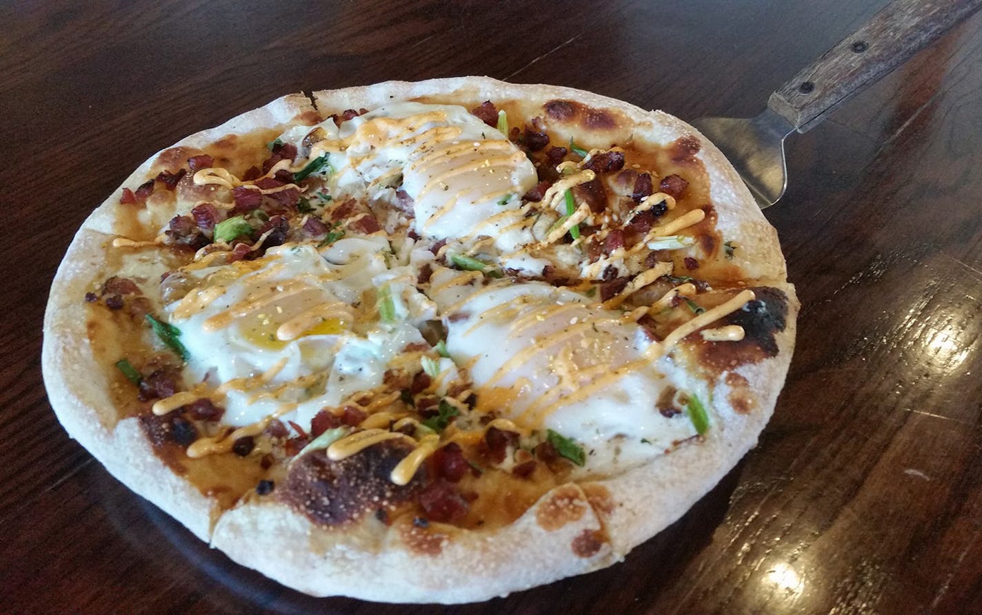 Eggs in Osaka pizza at Day Block pairs well with any of the six house beers on tap.