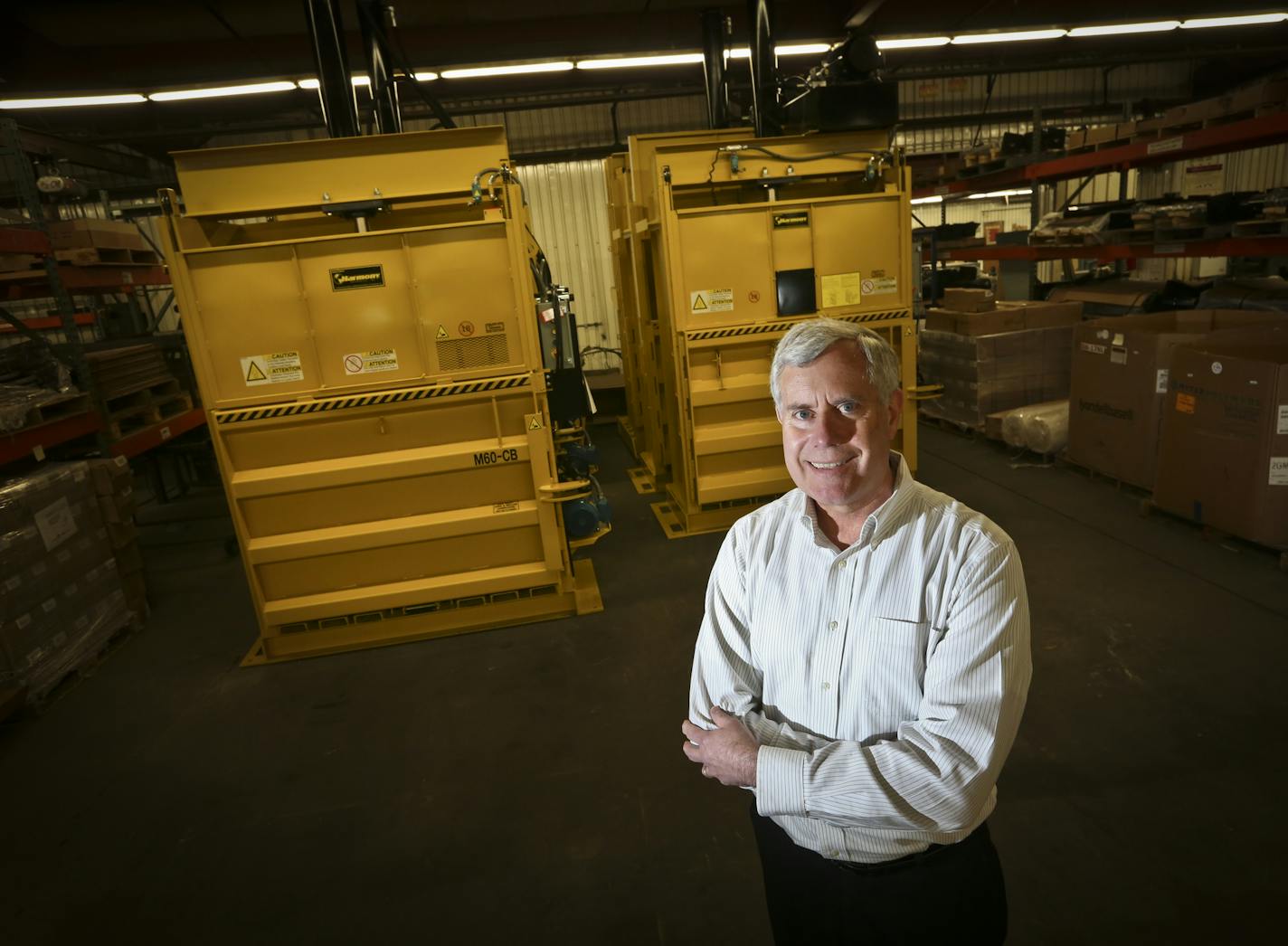 Owner Steve Cremer posed for a picture in front of two balers at Harmony Enterprises, Inc. in Harmony, Minn., on Thursday, March 21, 2013.] (RENEE JONES SCHNEIDER * reneejones@startribune.com)