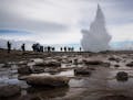Visitors watch the Strokkur geyser which is the most visited geyser in Iceland and is a common stop for tourists along the famed Golden Circle in Hauk