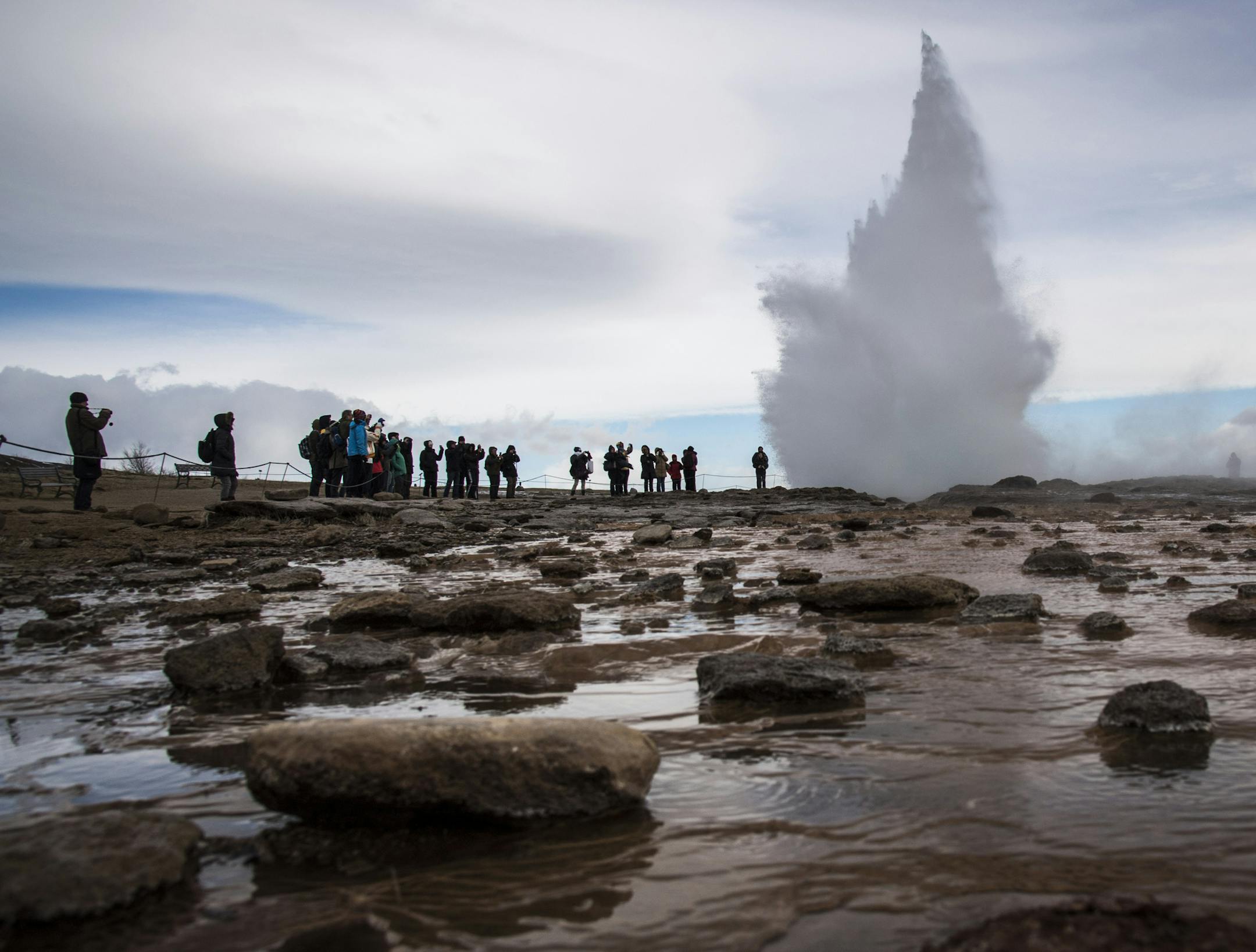 Visitors watch the Strokkur geyser which is the most visited geyser in Iceland and is a common stop for tourists along the famed Golden Circle in Haukadalsvegur, on April 27, 2016. MUST CREDIT: Washington Post photo by Jabin Botsford