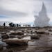 Visitors watch the Strokkur geyser which is the most visited geyser in Iceland and is a common stop for tourists along the famed Golden Circle in Hauk