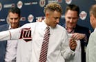 Twins chief baseball officer Derek Falvey, left, helped first overall MLB draft pick Royce Lewis into his new jersey as he was introduced to the media