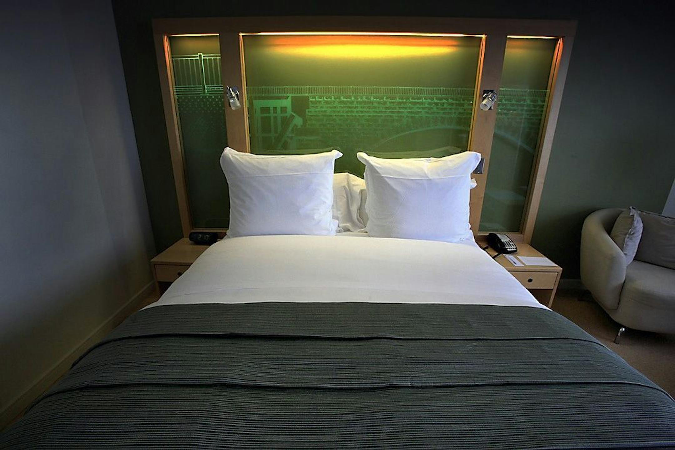 The executive level king room at the Graves 601 hotel in Minneapolis with an etched glass Stone Arch Bridge headboard.