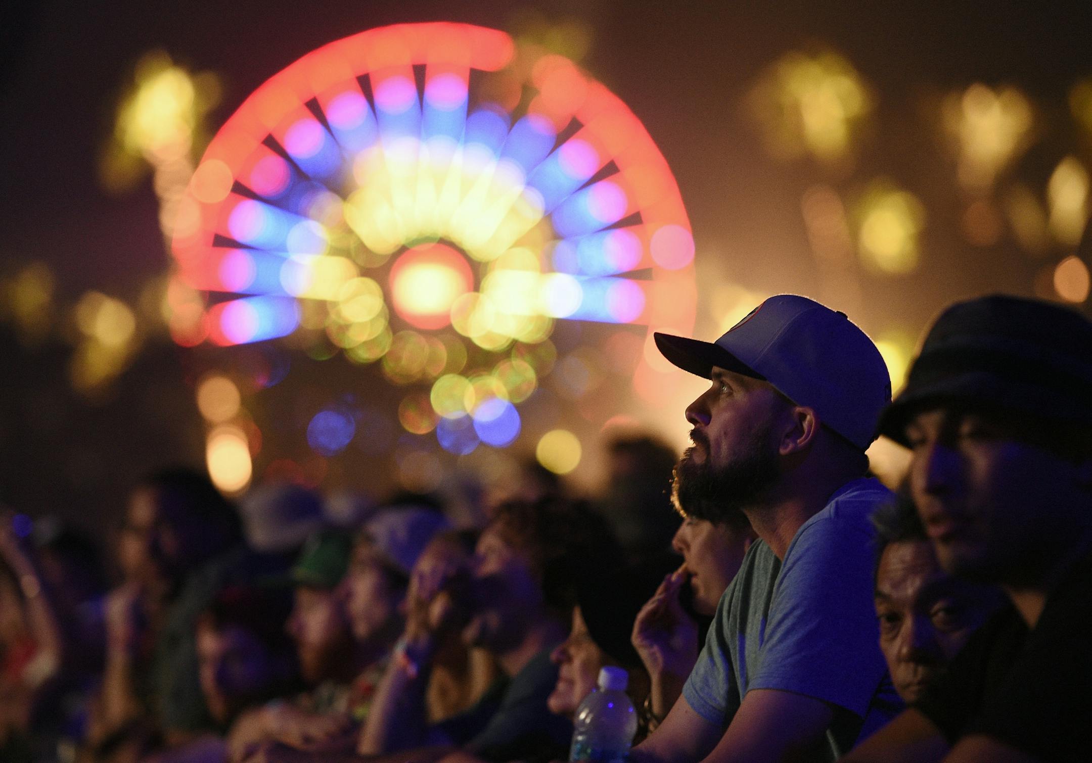 A festival goer watches Bob Dylan's performance on day 1 of the 2016 Desert Trip music festival at Empire Polo Field on Friday, Oct. 7, 2016, in Indio, Calif.